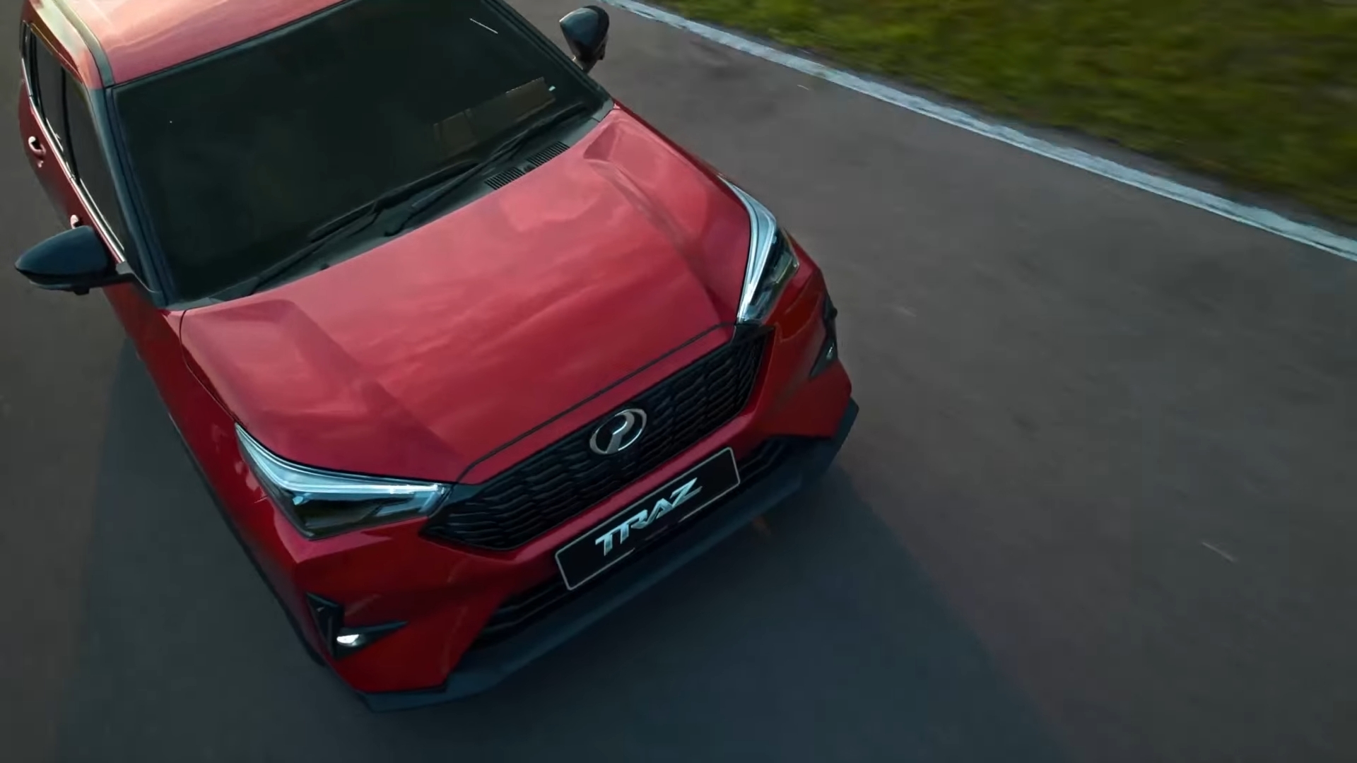 Red Perodua Traz driving on a road
